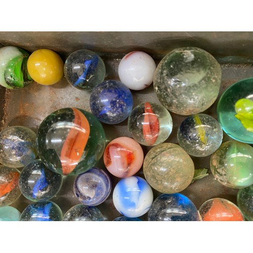 15 - Collection of vintage marbles in an old advertising tin