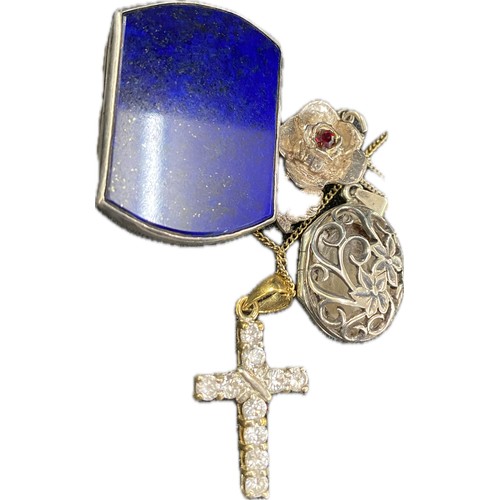 4 Silver pendants and chains to include a cross, a locket etc