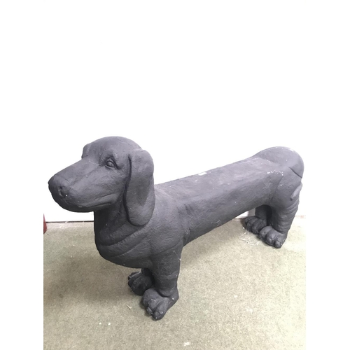 247 - Black painted metallic garden seat modelled as a standing dog 118 cm L