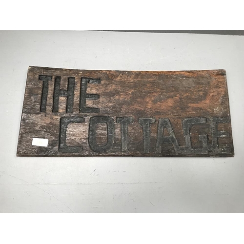 253 - African sign on hardwood 'The Cottage'