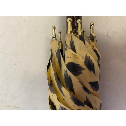 87 - A new leopard skin print design umbrella with gilded metal leopards head handle, from the Ancestral ... 