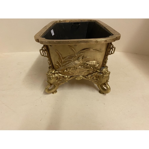 96 - Good gilded bronze oblong jardiniere, with relief decoration of exotic birds, the 4 feet of mythical... 