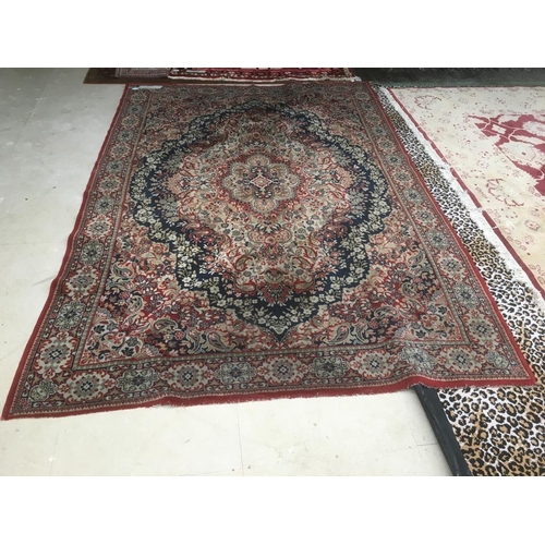 726 - Old traditional blue ground woollen rug with all over red and fawn stylised pattern   285 x 197