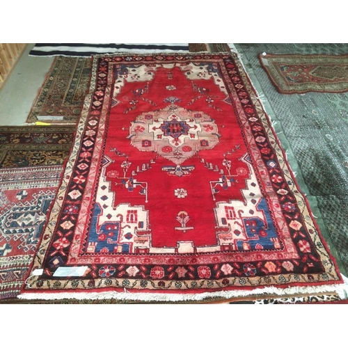 727 - Modern bright red ground woollen rug with central medallion and multi border 260 x 150