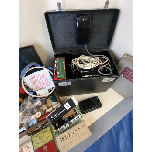 298 - Vintage Singer small electric Sewing machine in case, and a quantity of sewing items and books