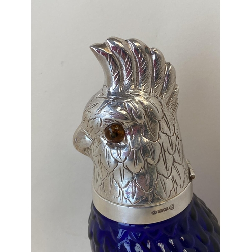 355 - Heavy moulded blue glass claret jug with an EPNS hinged lid in the form of a Cockatoo, 25cmH