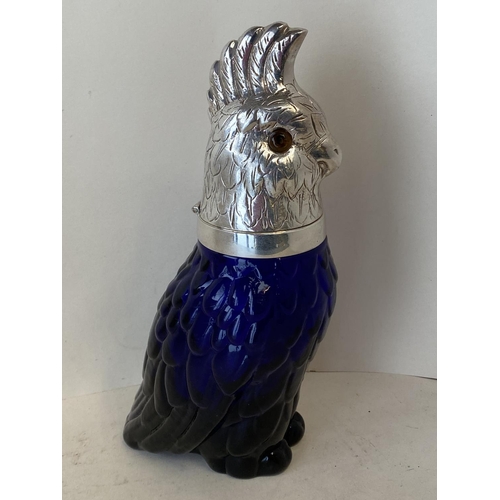 355 - Heavy moulded blue glass claret jug with an EPNS hinged lid in the form of a Cockatoo, 25cmH