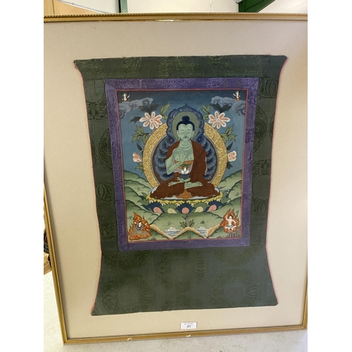 37 - Framed and glazed Tibetan Thangka, mounted within a green and purple fabric mount, size including fa... 