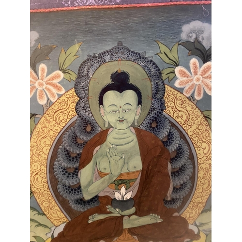 37 - Framed and glazed Tibetan Thangka, mounted within a green and purple fabric mount, size including fa... 