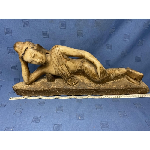 395 - Small stone carving of a reclining Buddha, overall length 70cm , originally partly gilded