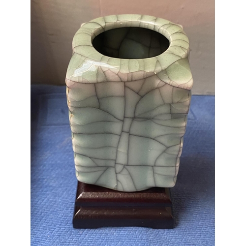 401 - An oriental ceramic jade coloured vase with mark on base and plinth