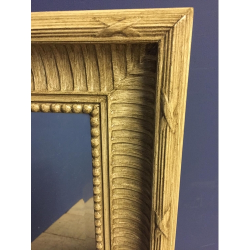 415 - Rectangular bevelled wall mirror, set within a cream/washed decorative frame88cm H x68cmW overall