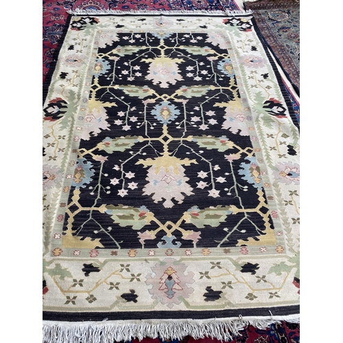 745 - Modern kelim style rug, with black ground and multi pattern, 262 x 140 cm (condition is good)