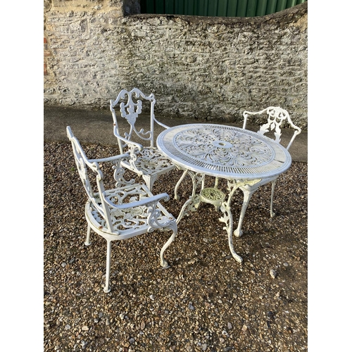 751 - Small circular white garden table and chairs