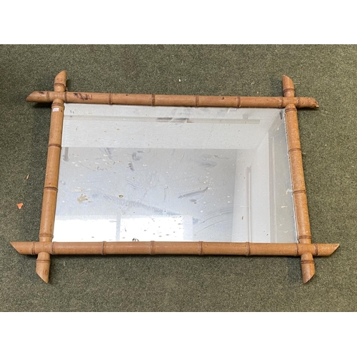 413 - Three wall mirrors, including a bevelled oval wall mirror in worn wooden  frame, and 2 rectangular m... 