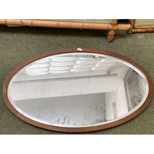 413 - Three wall mirrors, including a bevelled oval wall mirror in worn wooden  frame, and 2 rectangular m... 