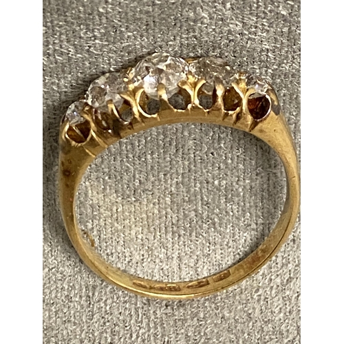 1 - An 18ct gold and diamond five stone ring, set with graduated line of old cut diamonds in a scrolling... 