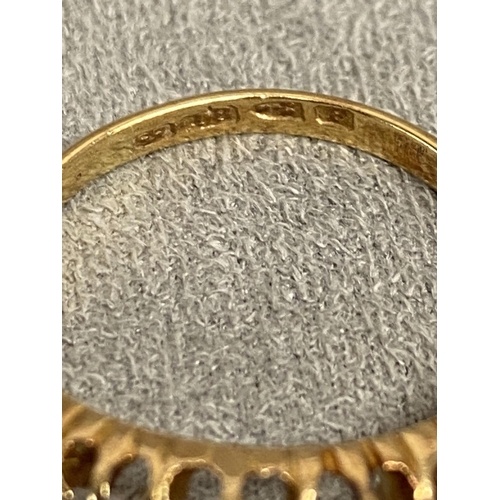 1 - An 18ct gold and diamond five stone ring, set with graduated line of old cut diamonds in a scrolling... 