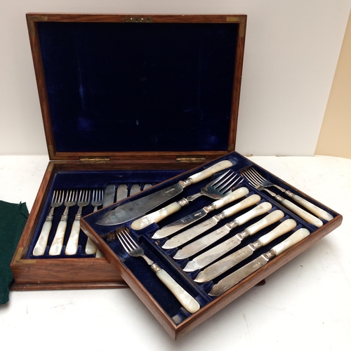 108 - A good cased set of Sterling silver fish knives and forks and servers, with mother of pearl handles,... 