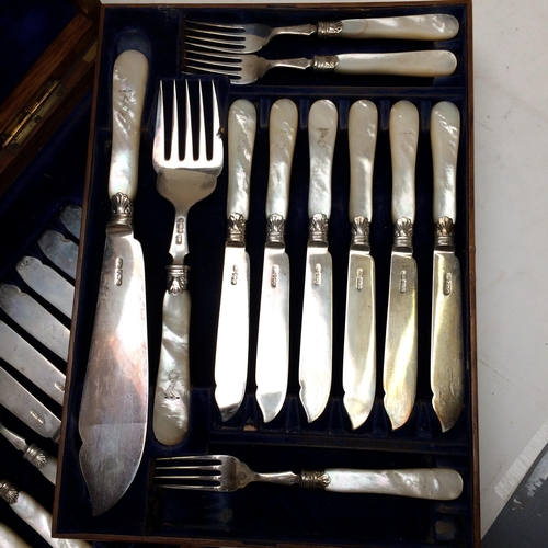 108 - A good cased set of Sterling silver fish knives and forks and servers, with mother of pearl handles,... 