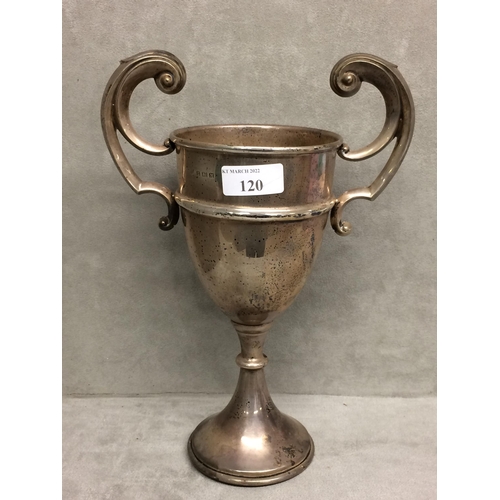 120 - Sterling silver trophy with scrolling handles on circular base, Birmingham 1936, 10.5ozt, 26cm H