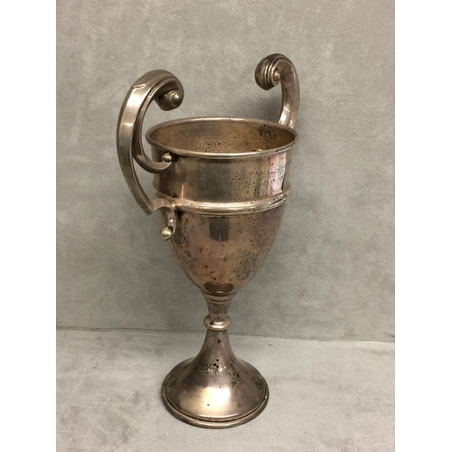 120 - Sterling silver trophy with scrolling handles on circular base, Birmingham 1936, 10.5ozt, 26cm H