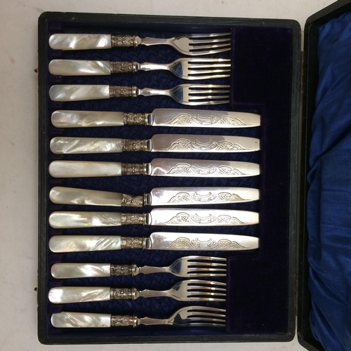 142 - A fitted cased ,six person set, of decorative engraved mother of pearl and white metal knife and for... 