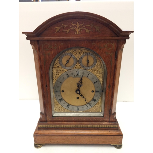 143 - A large square framed oak and brass inlaid bracket clock, E White, 20 Cockspur Street, London,  bras... 