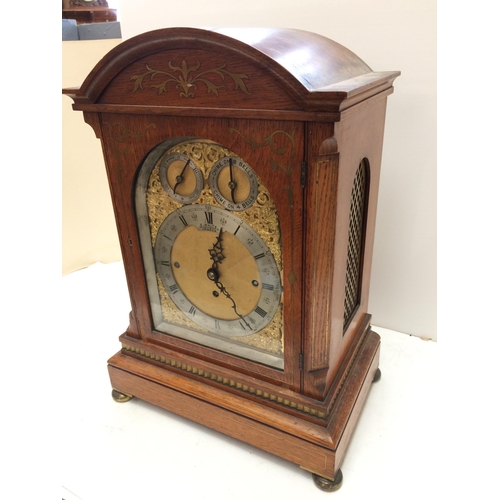 143 - A large square framed oak and brass inlaid bracket clock, E White, 20 Cockspur Street, London,  bras... 