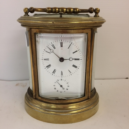 187 - French oval gilt brass four pane carriage clock, striking on a bell with key, losses to glass front ... 