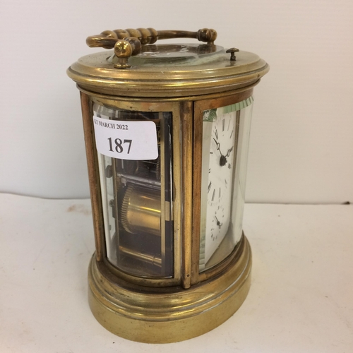 187 - French oval gilt brass four pane carriage clock, striking on a bell with key, losses to glass front ... 