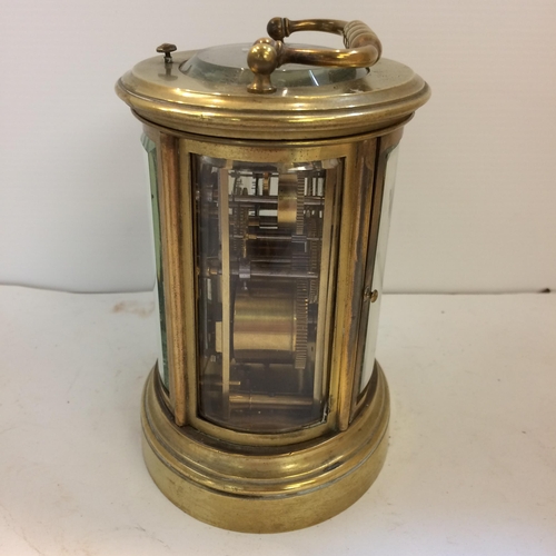 187 - French oval gilt brass four pane carriage clock, striking on a bell with key, losses to glass front ... 