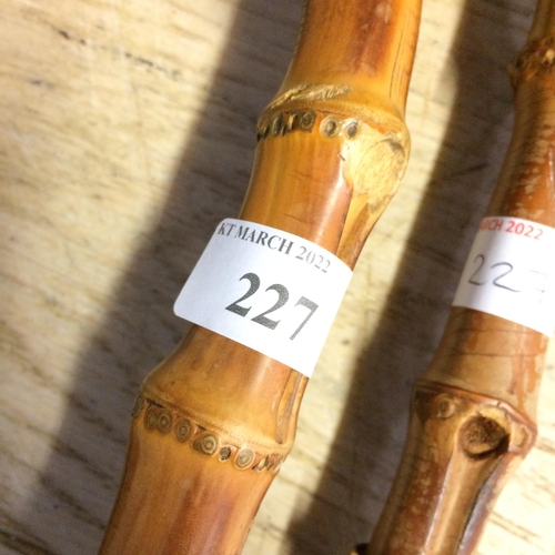 227 - Sticks & canes: 2 black and bamboo handled umbrellas and 2 hallmarked silver walking canes