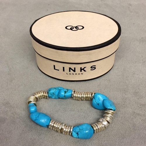 23 - Turquoise and white metal bracelet on elasticated strap