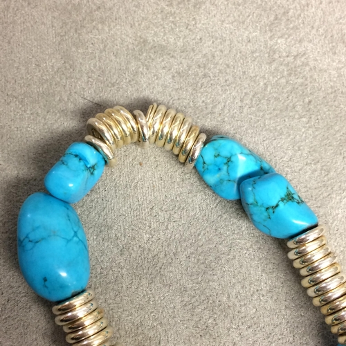 23 - Turquoise and white metal bracelet on elasticated strap