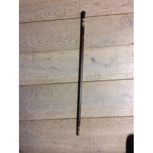 230 - A brass and wooden walking cane, with carved and bone inlaid patterns SWORD STICK