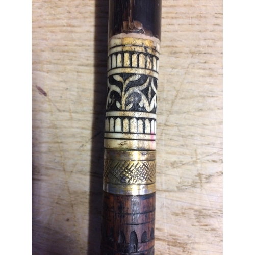 230 - A brass and wooden walking cane, with carved and bone inlaid patterns SWORD STICK