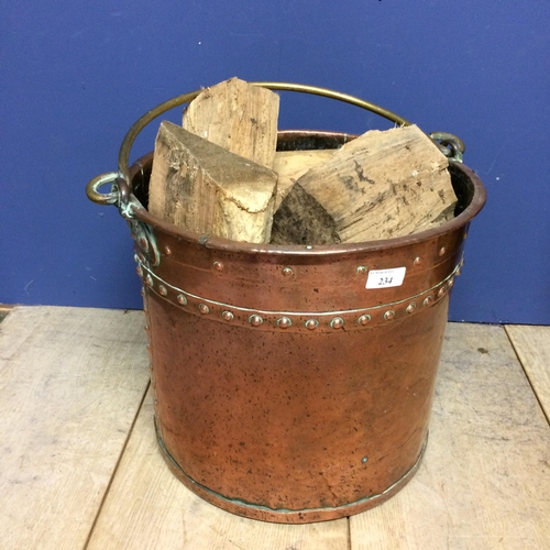 234 - Large brass bucket with handle (full of wood!)