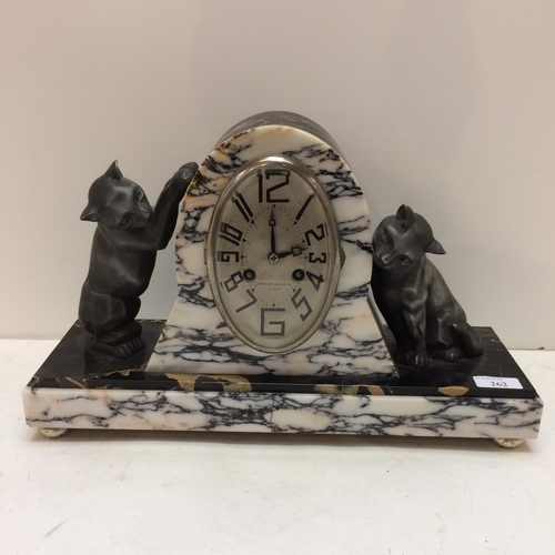 262 - A French slate and marble mantle clock, in the Art Deco taste, the oval dial marked 108-110 Rue Gamb... 