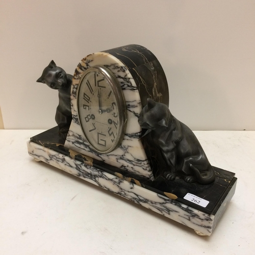 262 - A French slate and marble mantle clock, in the Art Deco taste, the oval dial marked 108-110 Rue Gamb... 