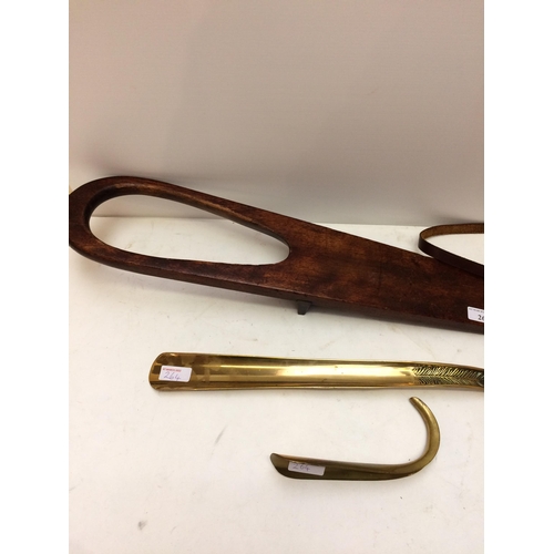 264 - A long brass shoe horn, and a short one, a mahogany boot jack, a pair of Vintage binoculars in case ... 