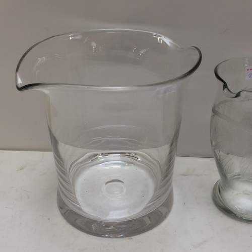 266 - a large heavy glass ice bucket/wine bucket, a tall etched glass jug, and a smaller one