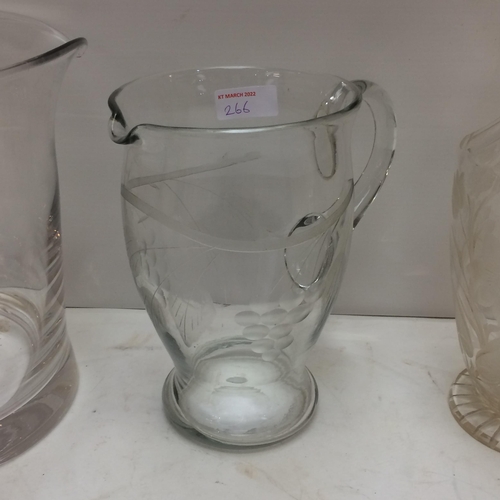 266 - a large heavy glass ice bucket/wine bucket, a tall etched glass jug, and a smaller one