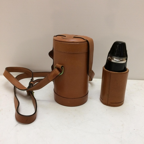 267 - A modern light tan leather hip flask with shoulder strap, the top opening to reveal 3 fitted glass b... 