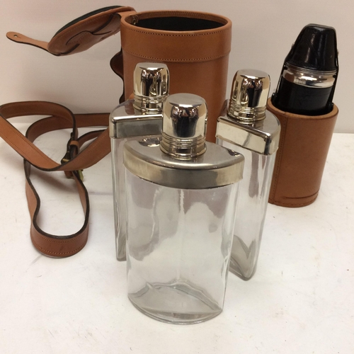 267 - A modern light tan leather hip flask with shoulder strap, the top opening to reveal 3 fitted glass b... 