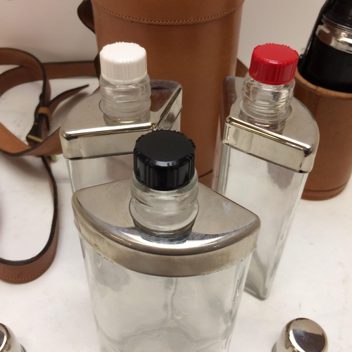 267 - A modern light tan leather hip flask with shoulder strap, the top opening to reveal 3 fitted glass b... 