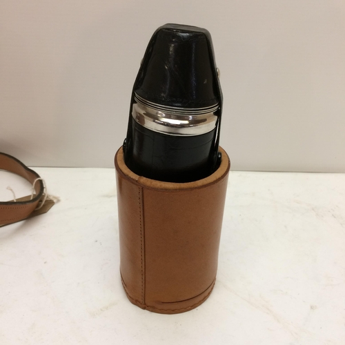 267 - A modern light tan leather hip flask with shoulder strap, the top opening to reveal 3 fitted glass b... 