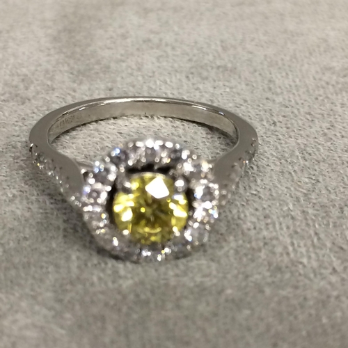 27 - Platinum fancy yellow diamond and diamond halo ring, central 0.64ct brilliant cut fancy yellow diamo... 