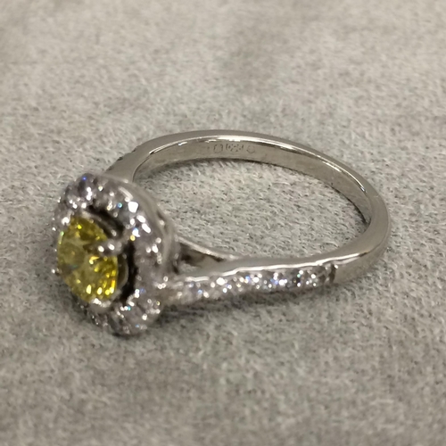 27 - Platinum fancy yellow diamond and diamond halo ring, central 0.64ct brilliant cut fancy yellow diamo... 