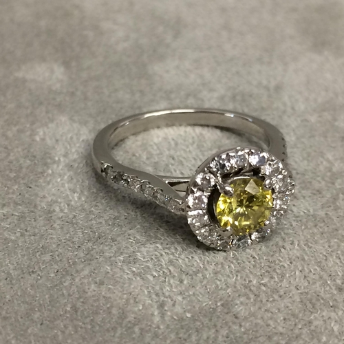 27 - Platinum fancy yellow diamond and diamond halo ring, central 0.64ct brilliant cut fancy yellow diamo... 